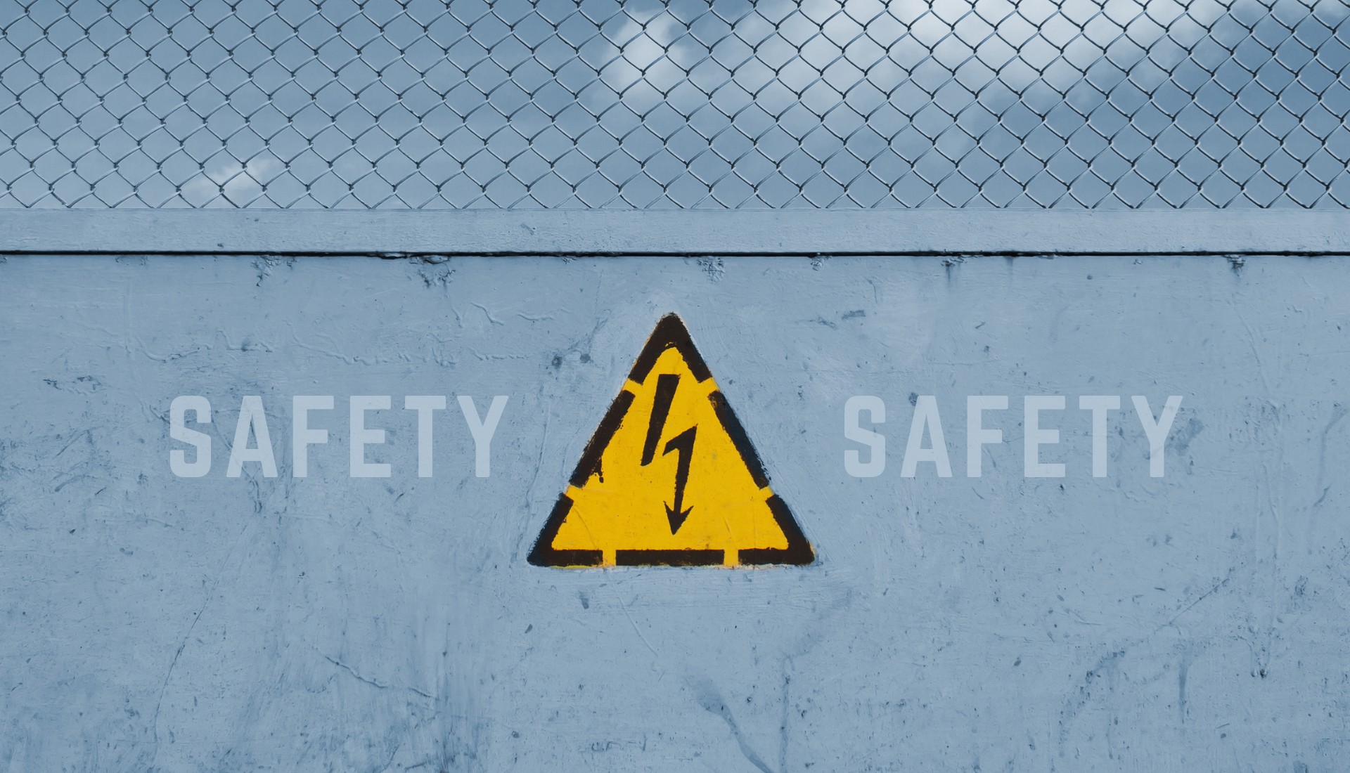 safety written on wall with electrical hazard sign